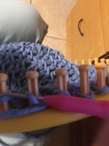 Using the loom to make the bag.