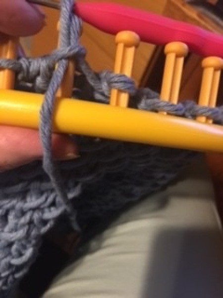 Using the loom to make the bag.