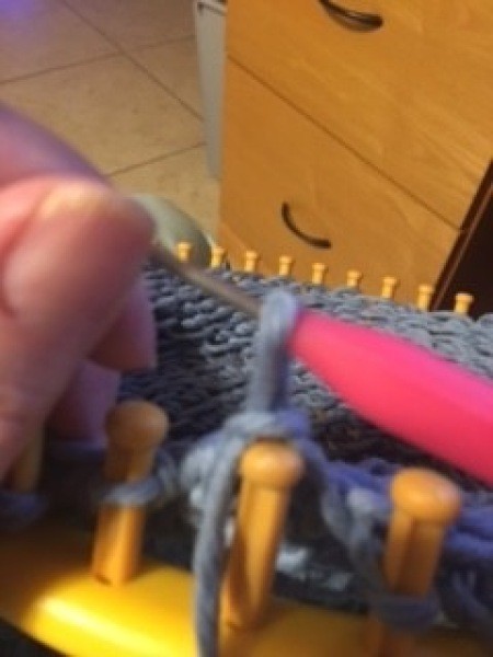 Using the loom to make the bag.