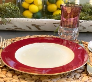 A china plate with a red rim.
