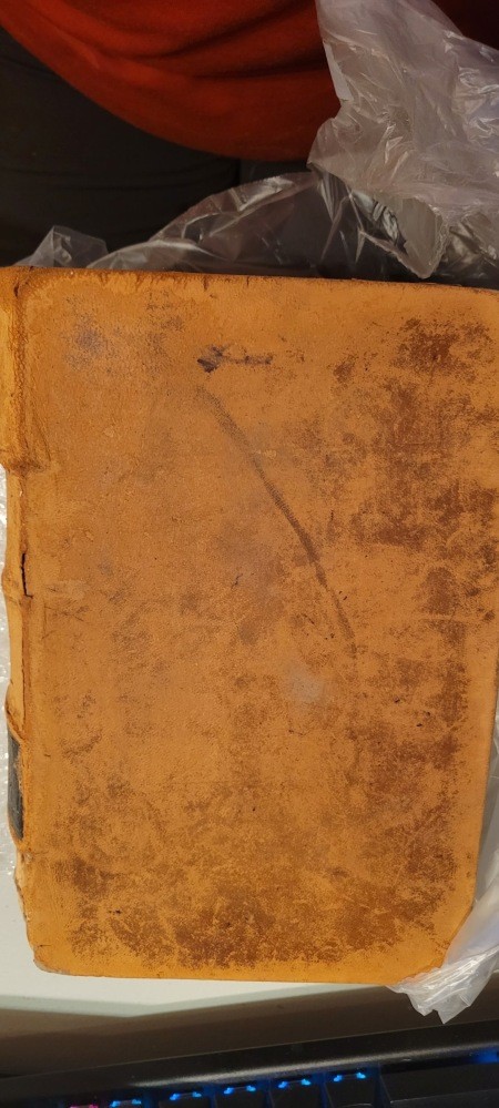 The cover of an old and worn dictionary.