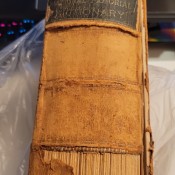 The worn spine of an old dictionary.