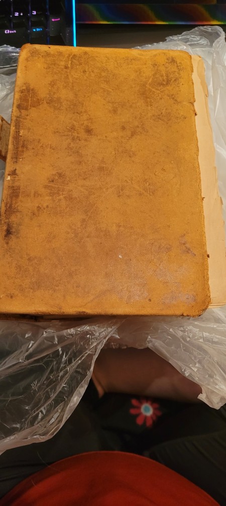 The cover of an old and worn dictionary.