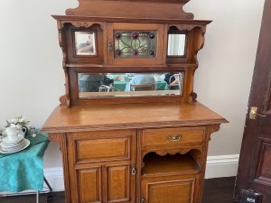 A wooden dresser with a cabinet top.