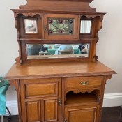 A wooden dresser with a cabinet top.