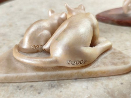 Dates on the back of cat figurines.