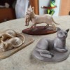 Three cat figurines.