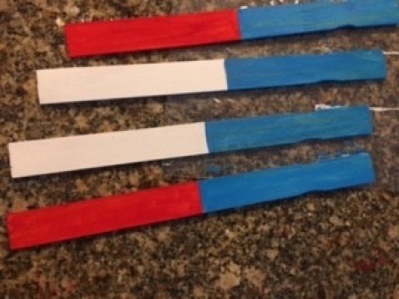 Sticks painted half blue and red, or half white and red.