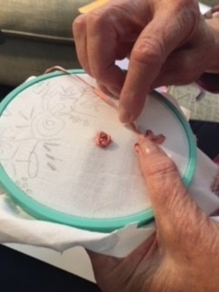 Embroidering with ribbon.