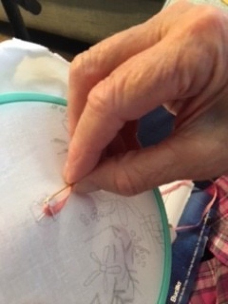 Embroidering with ribbon.