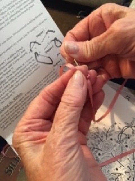 Sewing the ribbon into a pattern.