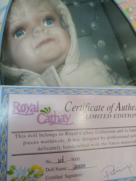 A porcelain doll with a certificate of authenticity.