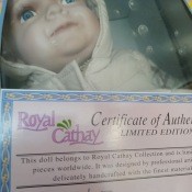 A porcelain doll with a certificate of authenticity.