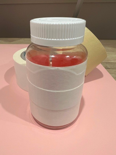 Wrapping tape around the container.