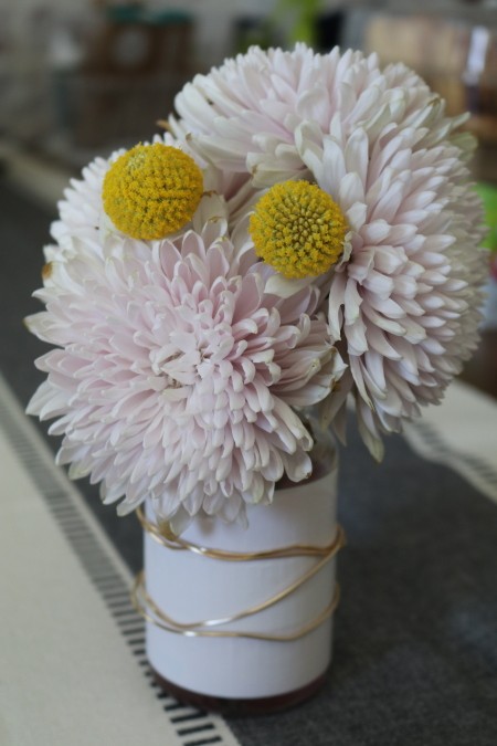 The finished vase filled with flowers.