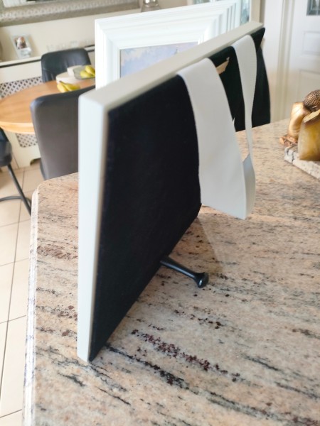 A hanging ribbon on the back of the picture.