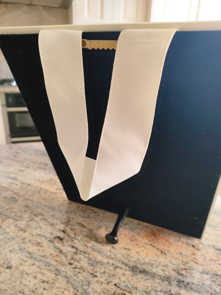 A hanging ribbon on the back of the picture.