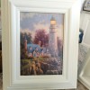 A small painting of a lighthouse.