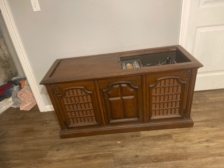 A wooden console record player.