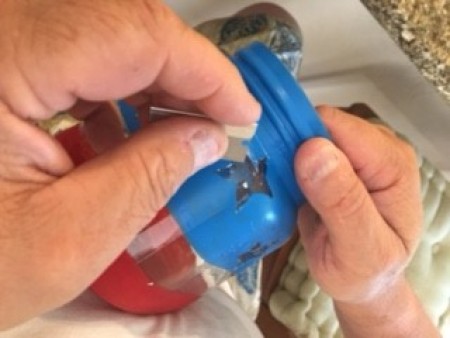 Removing star stickers from the jar.