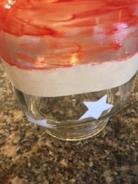 Painting the jar red on the bottom.