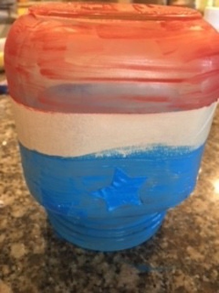 Painting the jar red, white and blue.
