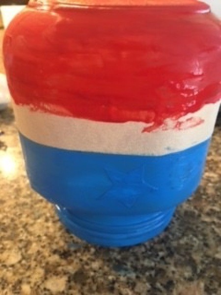 Painting the jar red, white and blue.