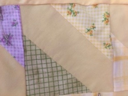 The sewn quilt square added to the rest of the quilt.