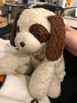 A brown and white stuffed dog.