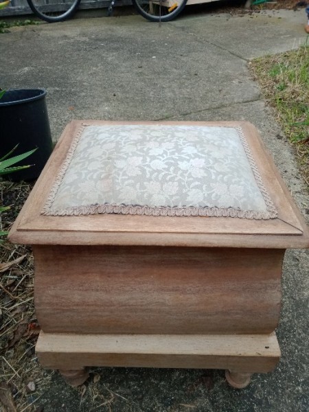 The closed wooden commode.