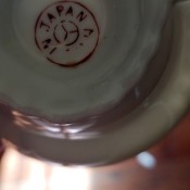 A marking on the underside of a china cup.