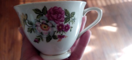 A china cup with a floral pattern.