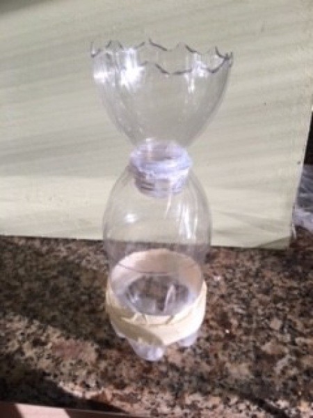 Assembling the plastic bottle pieces.