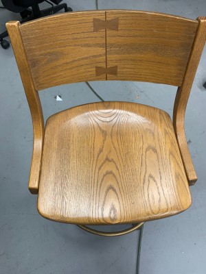 A wooden bar stool style chair.