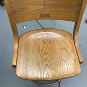 A wooden bar stool style chair.