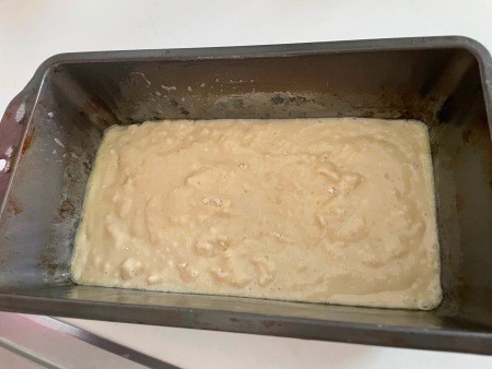 The bread dough in a pan.