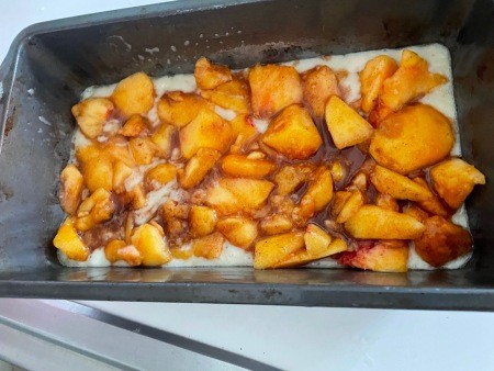 Adding the peaches to the pan.