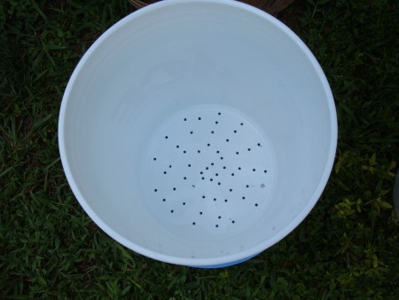 Holes drilled in the bottom of a bucket.
