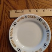 A small plate with a yellow and black design around the edge.