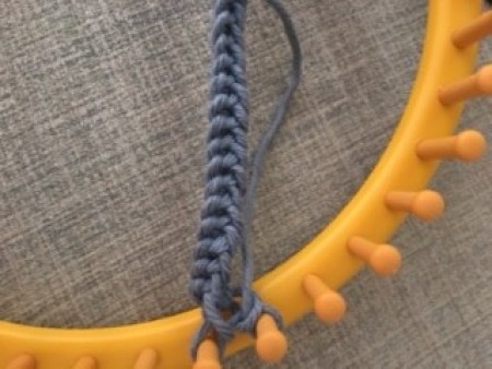 Using a loom to make the strap.