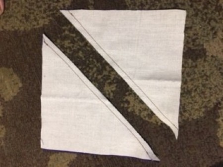 Two triangles of white fabric.