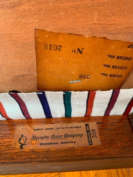 The marking on the underside of a wooden chair.