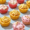 Rows of brightly colored cupcakes.