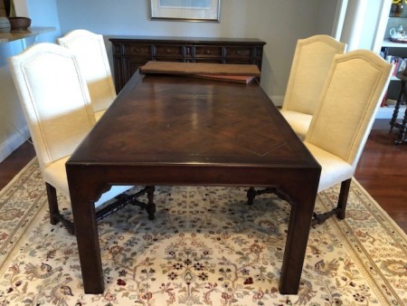 A dining table with four chairs.