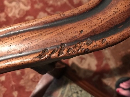 A close up of the carved wooden frame.