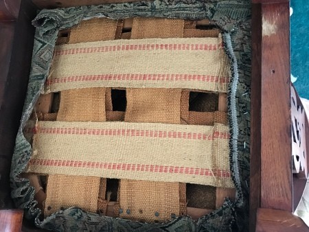 The underside of an antique chair.