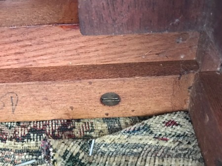 The underside of an antique chair.