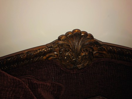 The carved top of the sleigh couch.