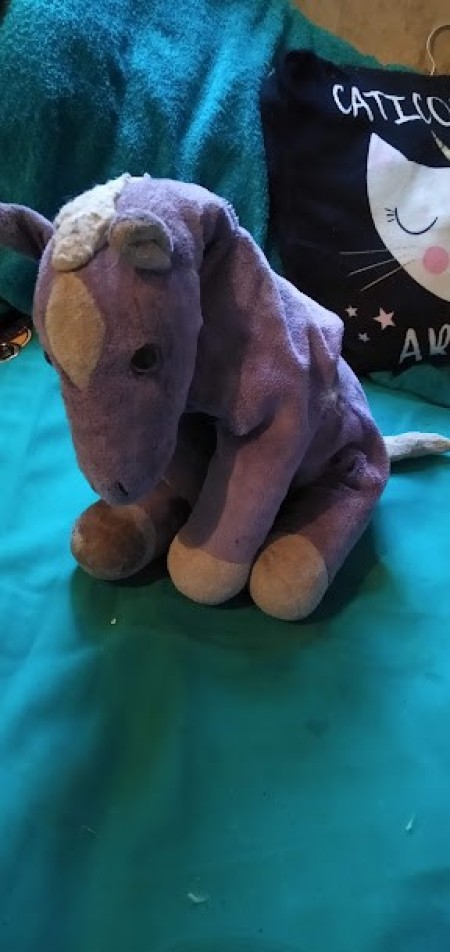 A small purple stuffed horse.