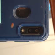 A small red bug on the back of a phone case.